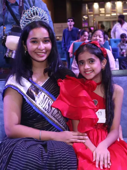 An inspiring moment for a young participant, getting to meet and pose with a pageant queen.