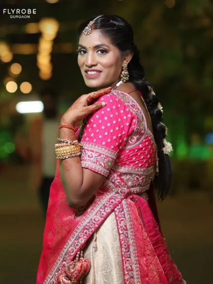 A close-up of this beautiful bride or guest in a pink and cream lehenga. The intricate details on the blouse and the traditional jewellery are stunning.