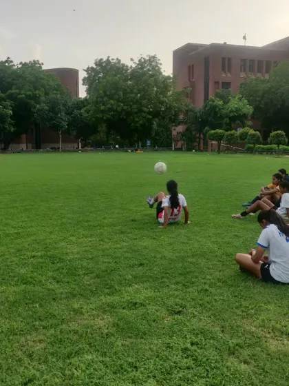 A moment of fun and skill during a break in training. A player practices her juggling, showcasing the joy and creativity we encourage.