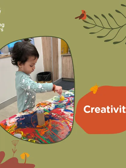 Creativity flourishes when children are given the freedom to explore materials without a predetermined outcome. This child uses a roller to spread paint, discovering patterns and textures through their own actions and curiosity.