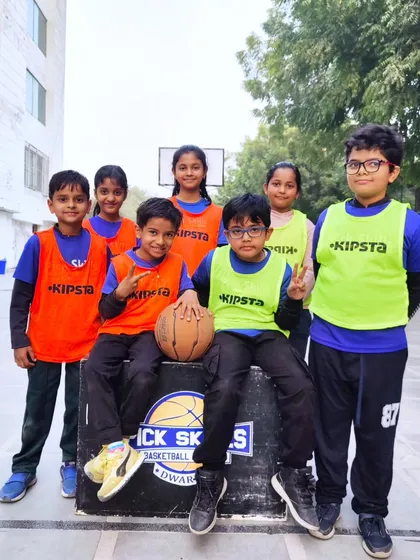 Basketball is a team sport, and our academy is a family. This group of young players, a mix of boys and girls, showcases the friendships and camaraderie that are built during our coaching sessions. We foster a positive environment where every child feels like part of the team.