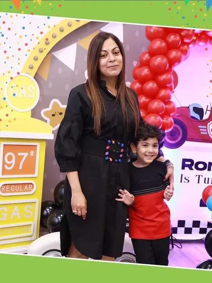 A mother and her son posing in front of a "Cars" themed birthday setup. We work with you to create the perfect theme for your child.