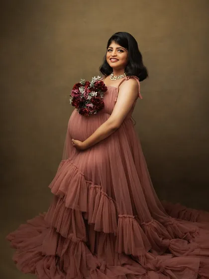 Holding a bouquet, her smile is radiant. This portrait is a beautiful blend of classic styling and genuine emotion.