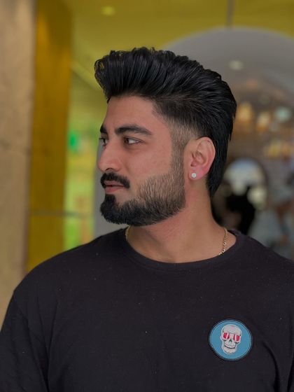 This side profile highlights the precision of the fade and the expert styling of the hair on top. A truly clean look.