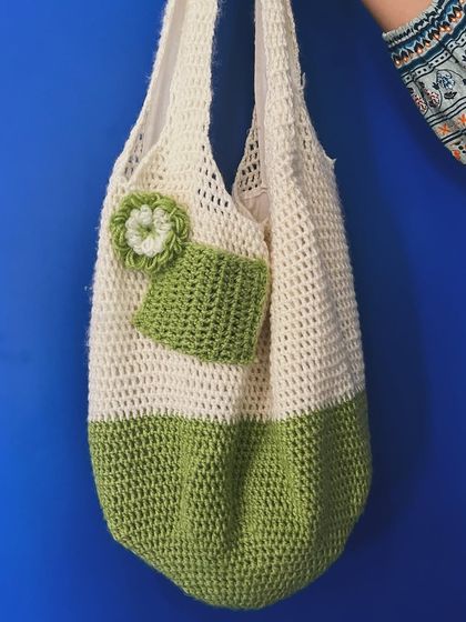 A closer look at the green and white tote bag. You can see the handy external pocket, perfect for slipping your phone or keys into.