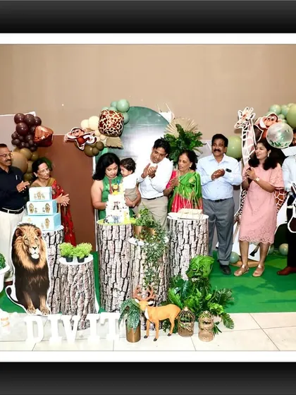 A wonderful group photo of the happy clients and their guests celebrating in front of the jungle safari backdrop.