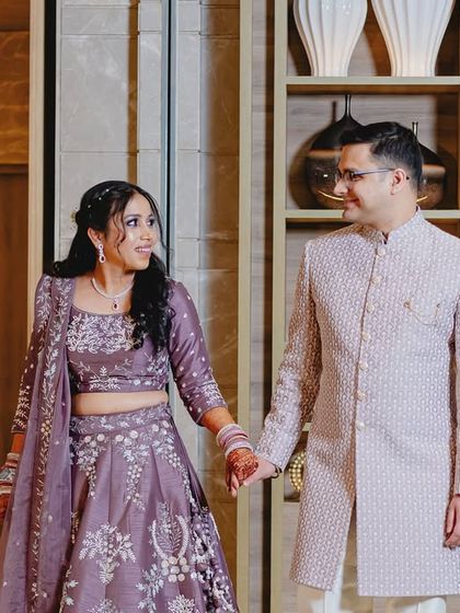 Holding hands and sharing a look. This photograph captures the easy, comfortable love between the couple during their pre-wedding event.