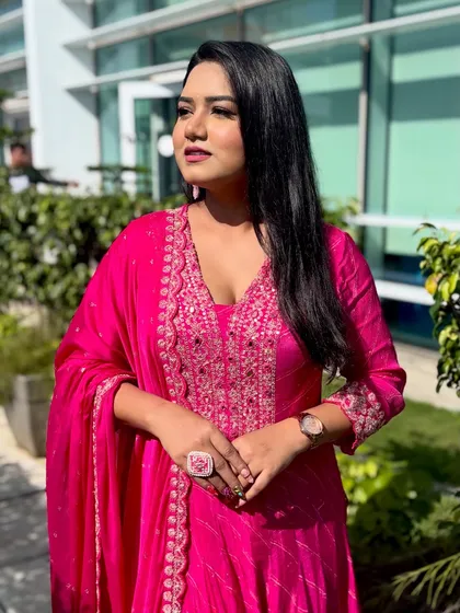 Posing in my vibrant pink suit. The color is so cheerful and photographs beautifully, making it a great choice for any celebration.