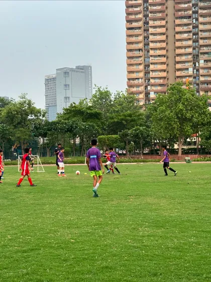Our players moving the ball during a friendly match, showcasing the passing and movement we drill in training.