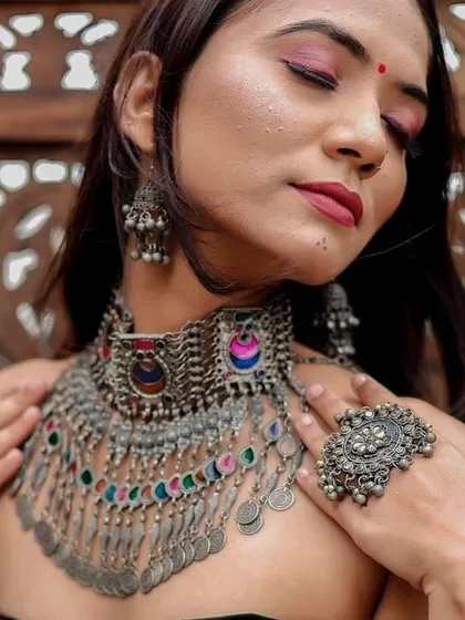 A close-up of a multi-colored oxidised choker with coin details. This piece is perfect for adding a bohemian touch to any festive outfit.