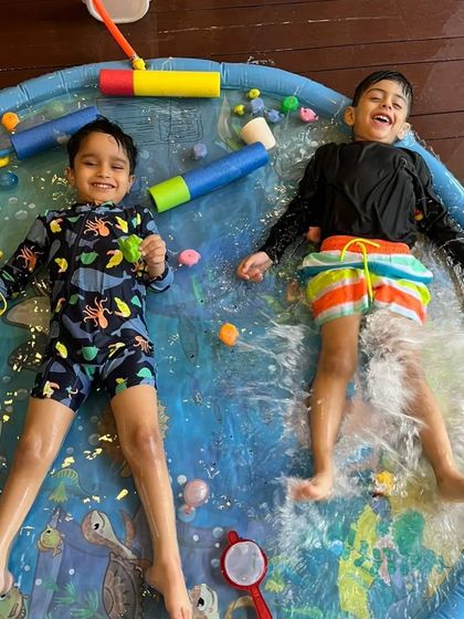 Two boys laughing and splashing during our Holi event. It’s moments like these that make our festival celebrations so special.