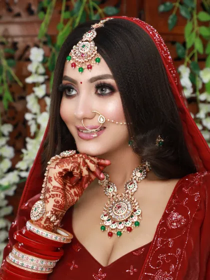 This bride looks stunning in her red lehenga. I gave her a classic look with defined eyes, a red bindi, and a smile that lights up the frame.