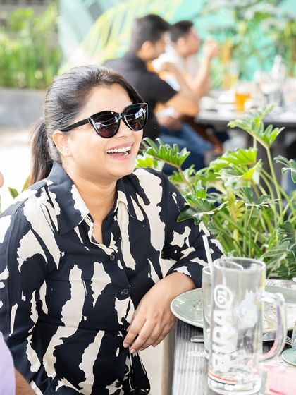 A guest laughing and enjoying a conversation over brunch. This is the relaxed, happy atmosphere I strive to create every day.