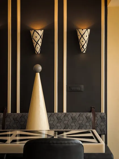 The black dining zone at Masala offers a more intimate and formal experience. We used hand-painted cone lights and geometric patterns on the upholstery and table to create a sophisticated atmosphere grounded in craft and detail.