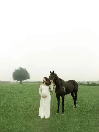 A dreamlike moment in a misty field, where the gentle presence of a horse adds a touch of magic. This image shows our love for creating unique, ethereal outdoor maternity portraits that feel like they are lifted from a fairytale.
