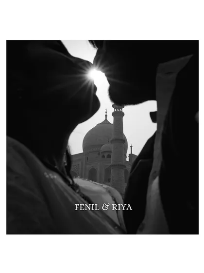 A timeless silhouette against the Taj Mahal. We framed this iconic monument within the couple's near-kiss, creating an artistic and deeply romantic black and white portrait that symbolizes eternal love.