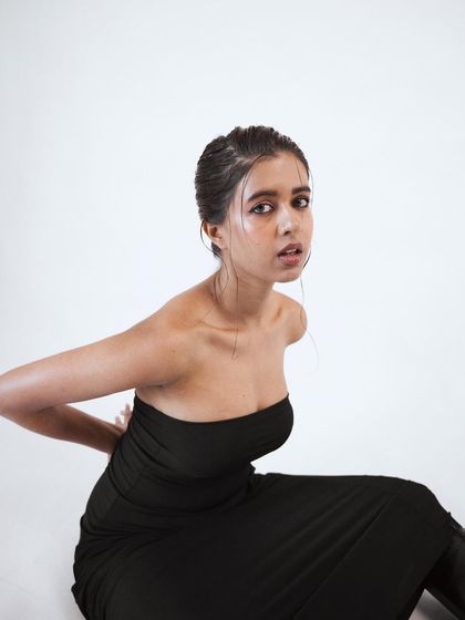 A close-up portrait with a raw, intense feel. The simple styling and the model's expression are the focus, creating a powerful and authentic image.