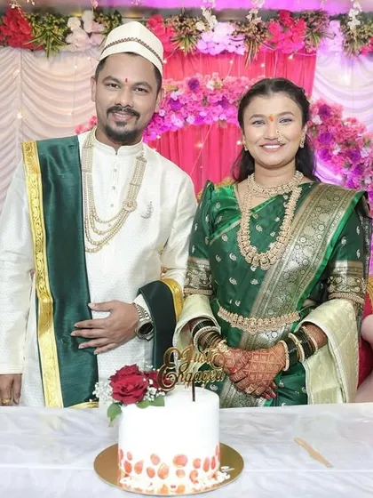 A lovely couple celebrating their Sakharpuda, or engagement ceremony, with one of our custom cakes. The simple design with red roses and a "Just Engaged" topper complements their traditional attire beautifully.