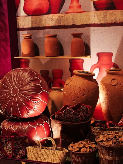 A corner of the pottery market, featuring terracotta pots, leather ottomans, and woven baskets. The earthy tones and rustic textures provided a beautiful contrast to the more opulent areas of the event.