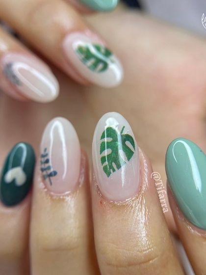 A close-up of the tropical leaf nail art, showing the cute heart detail and different leaf designs.