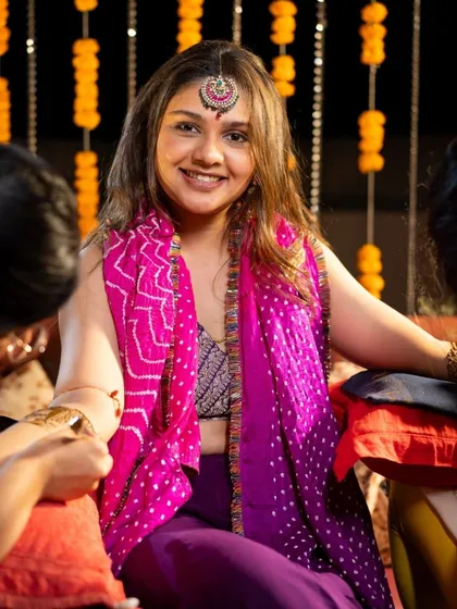 A happy bride at her mehendi ceremony, surrounded by festive decor. I love being part of such vibrant celebrations.