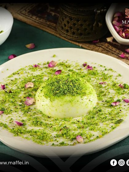 Mahalabia, a traditional Middle Eastern milk pudding. Ours is velvety smooth, flavored with rosewater, and generously topped with crushed pistachios and rose petals.