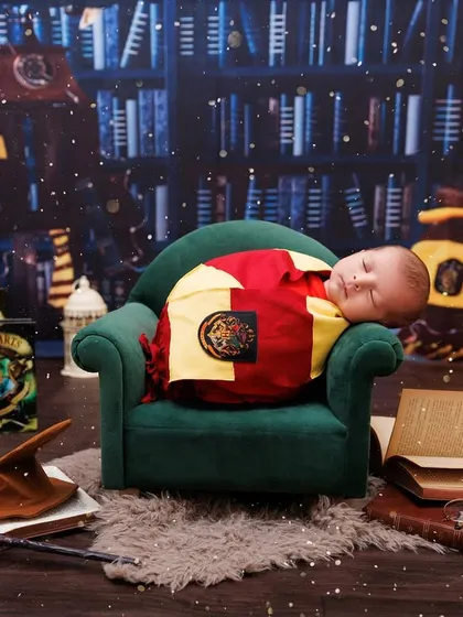 A wide shot of the sleeping baby wizard, showcasing the entire enchanting Hogwarts library backdrop.