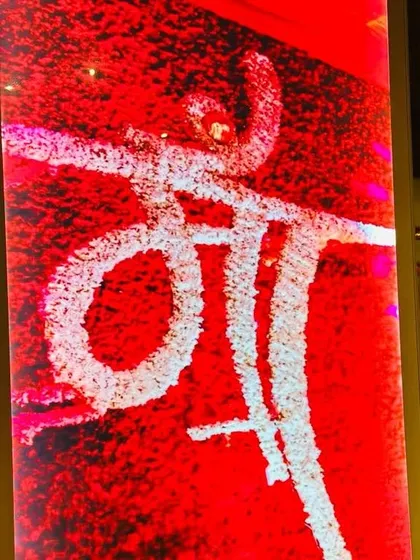 Detail is everything. For this event, I created this beautiful 'Maa' signage using white flowers against a textured red background, adding a personal and heartfelt touch to the devotional decor.