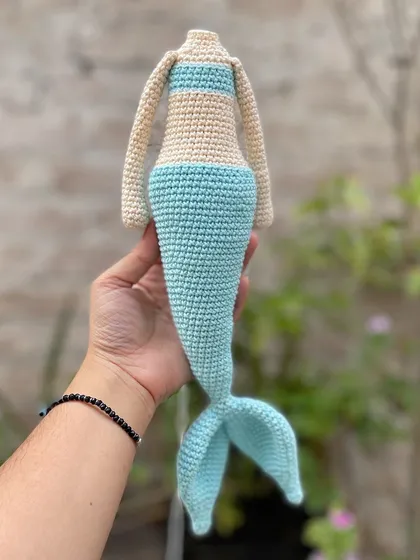 This is the body of a mermaid doll in progress. I used a lovely sea blue and aqua green for her tail, creating a beautiful ocean-inspired look.