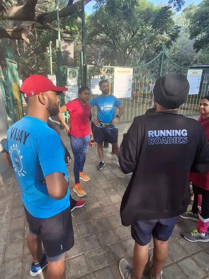 A small group discussion after a training session. We always take time to cool down, stretch, and talk about the run. This is where we share tips, plan future runs, and just connect as a group.