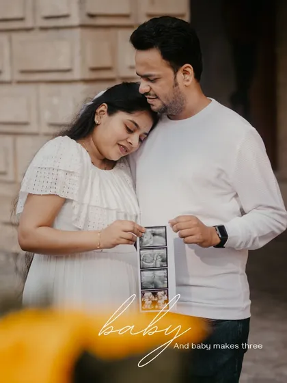 A touching moment where the couple looks at their baby's ultrasound photos. These are the pictures that tell the very first chapter of their new family story.