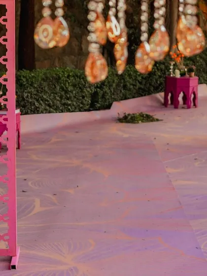 The flooring itself can be a design element. I used this custom printed floor with a delicate floral pattern to complement the pink and pastel theme of the Mehendi.