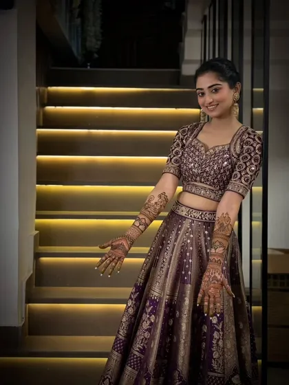 A full portrait of a radiant bride, showcasing how our intricate arm-length mehandi completes the perfect bridal look for her special day.
