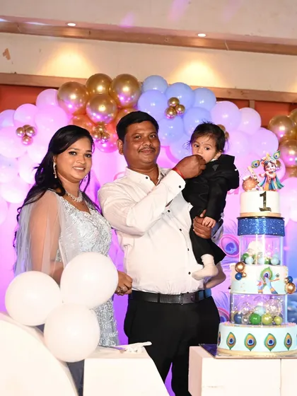 A sweet moment as the father helps his son taste the frosting from his first birthday cake.
