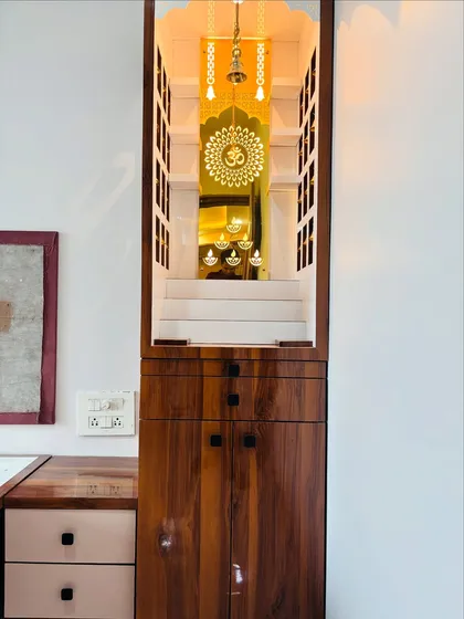 A full view of the mandir placed next to a study table, showing how a sacred space can be integrated into a functional room.