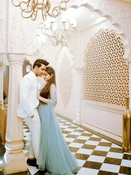 An intimate pose in a beautifully designed corridor. The intricate architecture and warm lighting create a romantic atmosphere, perfectly framing the couple's embrace.