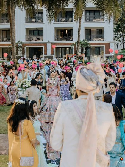 A beautiful shot of the bride, Kriti, walking down the aisle with her family at her destination wedding in Goa. We capture the emotional support and joy of family during these significant processions.