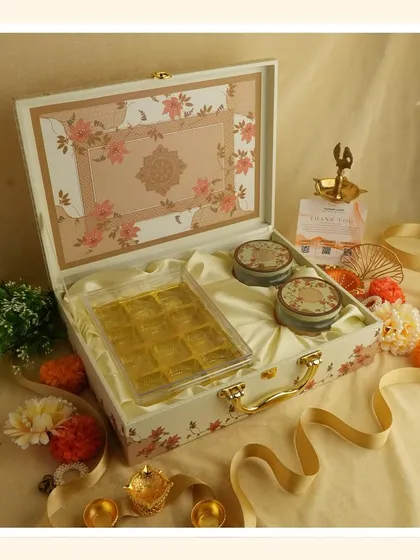 Embrace the purity of white for Navratri. This elegant floral suitcase box is perfect for gifting sweets and dry fruits as you transition into the Diwali season.