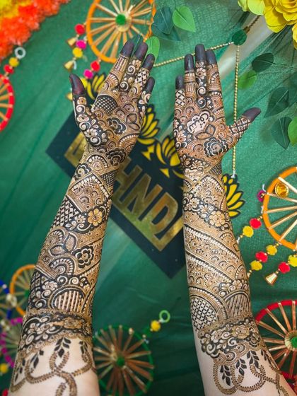 A full view of Sonu's back-of-hand mehendi against the festive decor.