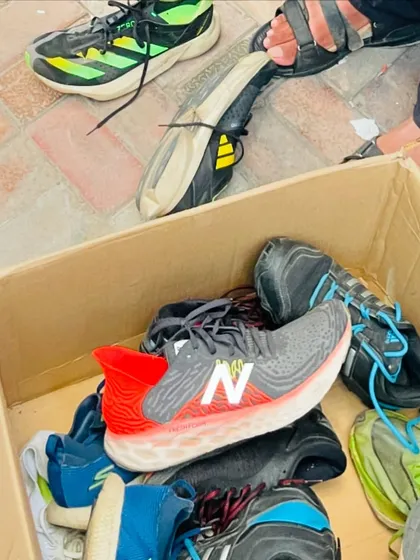 A box full of running shoes ready for distribution. This is a testament to the generosity of our community and sponsors.