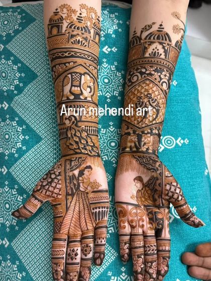 A design featuring portraits of a bride and groom offering flowers, with elephants and peacocks on the arms.