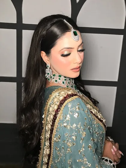 A close-up on the eyes, showing the soft, shimmery shadow and a perfect winged liner.