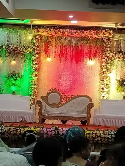 A beautifully decorated sangeet stage with floral arrangements and elegant lighting, all set for the performances.