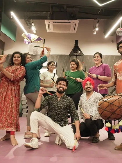 Our members and trainers pose with dandiya sticks and a dhol during our Navratri celebration, blending culture, fun, and fitness.