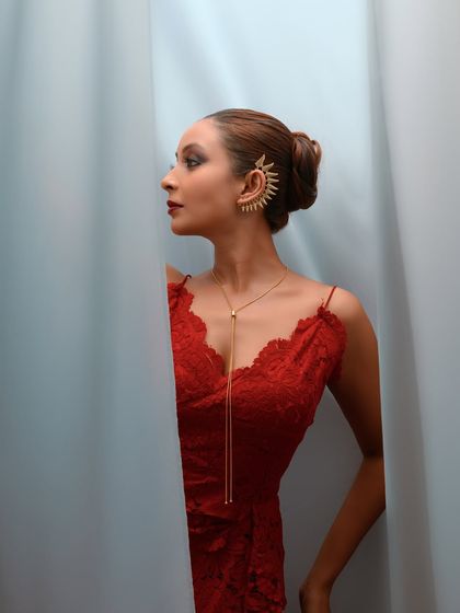 A side profile that showcases the intricate ear cuff and the elegant line of the neck and shoulder.