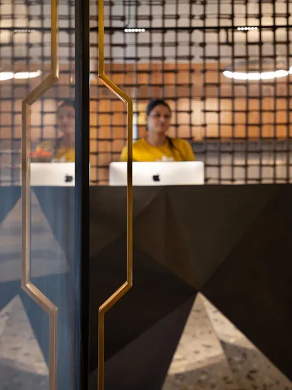 The door handle detail, crafted from steel, echoes the geometric and industrial themes of the office. It is a small but important part of a cohesive design narrative.
