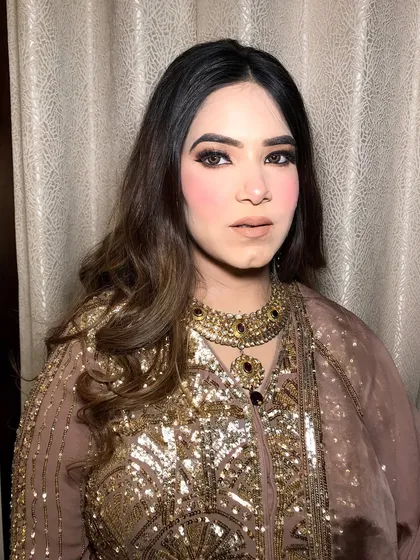 A frontal view, showing how the jewelry complements her soft, glam makeup.