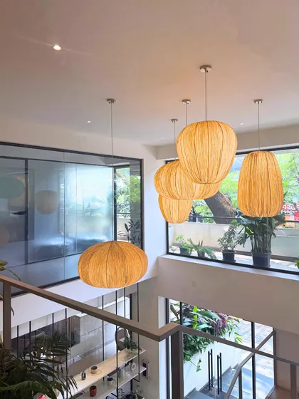 The view from the mezzanine at our Indiranagar cafe, highlighting the double-height ceiling, natural light, and our signature woven pendant lights.