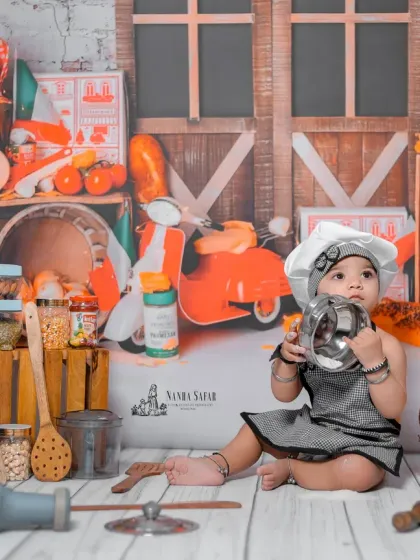 Making some noise with pots and pans. This playful action shot is a perfect memory of a baby's fun-loving nature at this age.