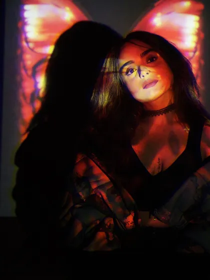 Another shot from the butterfly projection series. The play of light and shadow on my face represents the different facets of my personality and my music.